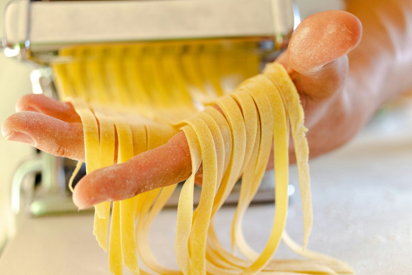a person holding a yellow container with yellow cables