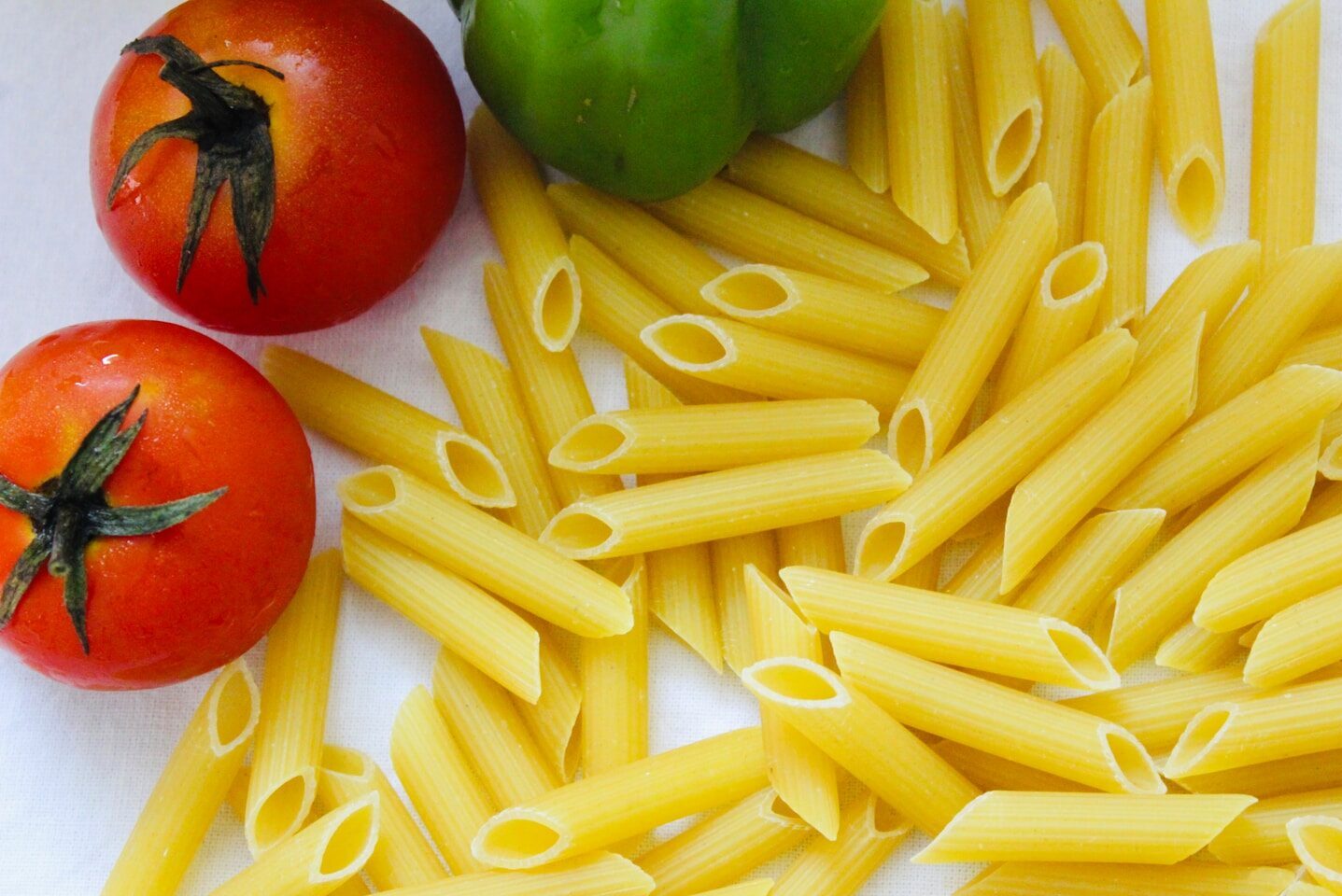 red tomato beside green bell pepper